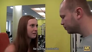 A young redhead in a gym blowjob fetish gym