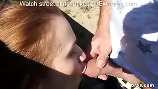 A redhead streetwalker gives a blowjob car cock suck